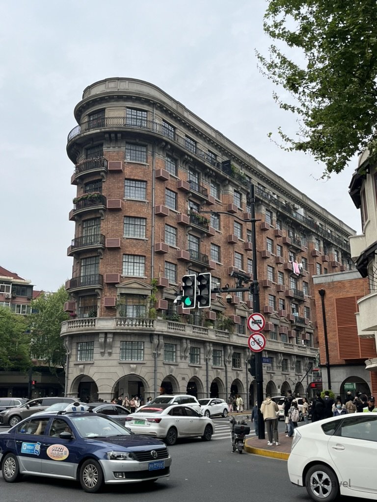 Shanghai City Walk — What I Got Wrong and What I'd Do Differently 上海武康大樓(Wukang Mansion),位於淮海中路與武康路口的紅磚弧形租界建築,是上海知名城市地標之一